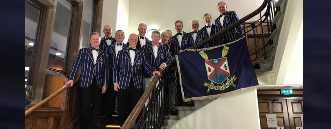 Former Queen's rowers gather on the stairs of Riddel Hall
