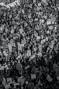 Black and white aerial image of protestors.  Many Black Lives Matter plaques visible