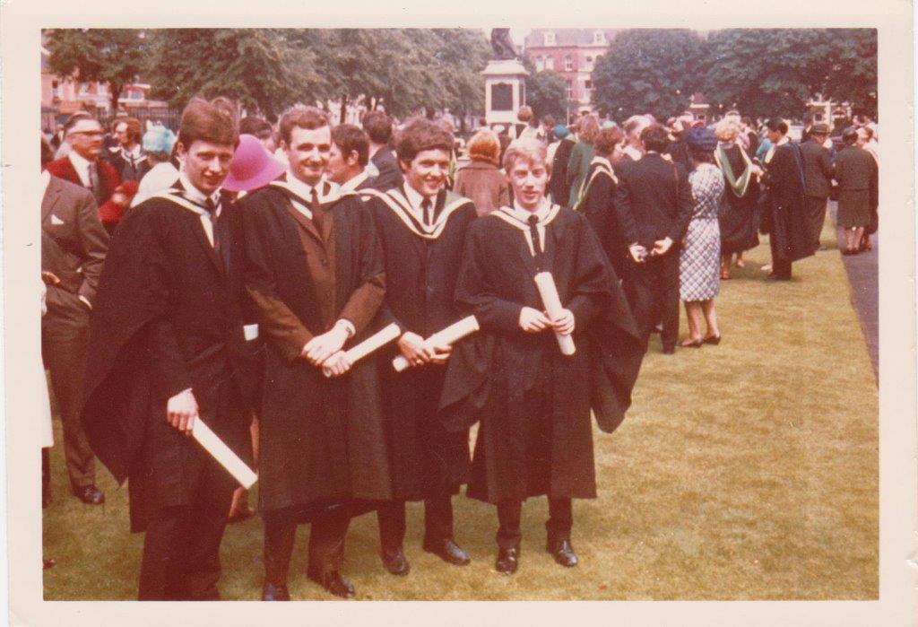 4 friends celebrating their graduation on Queen's front lawn