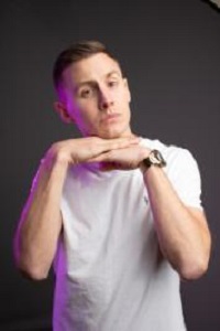 Profile picture of Shane Todd wearing white tshirt and resting chin on hands