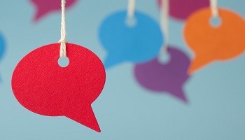 Speech bubbles in red, blue, orange and purple hanging by string