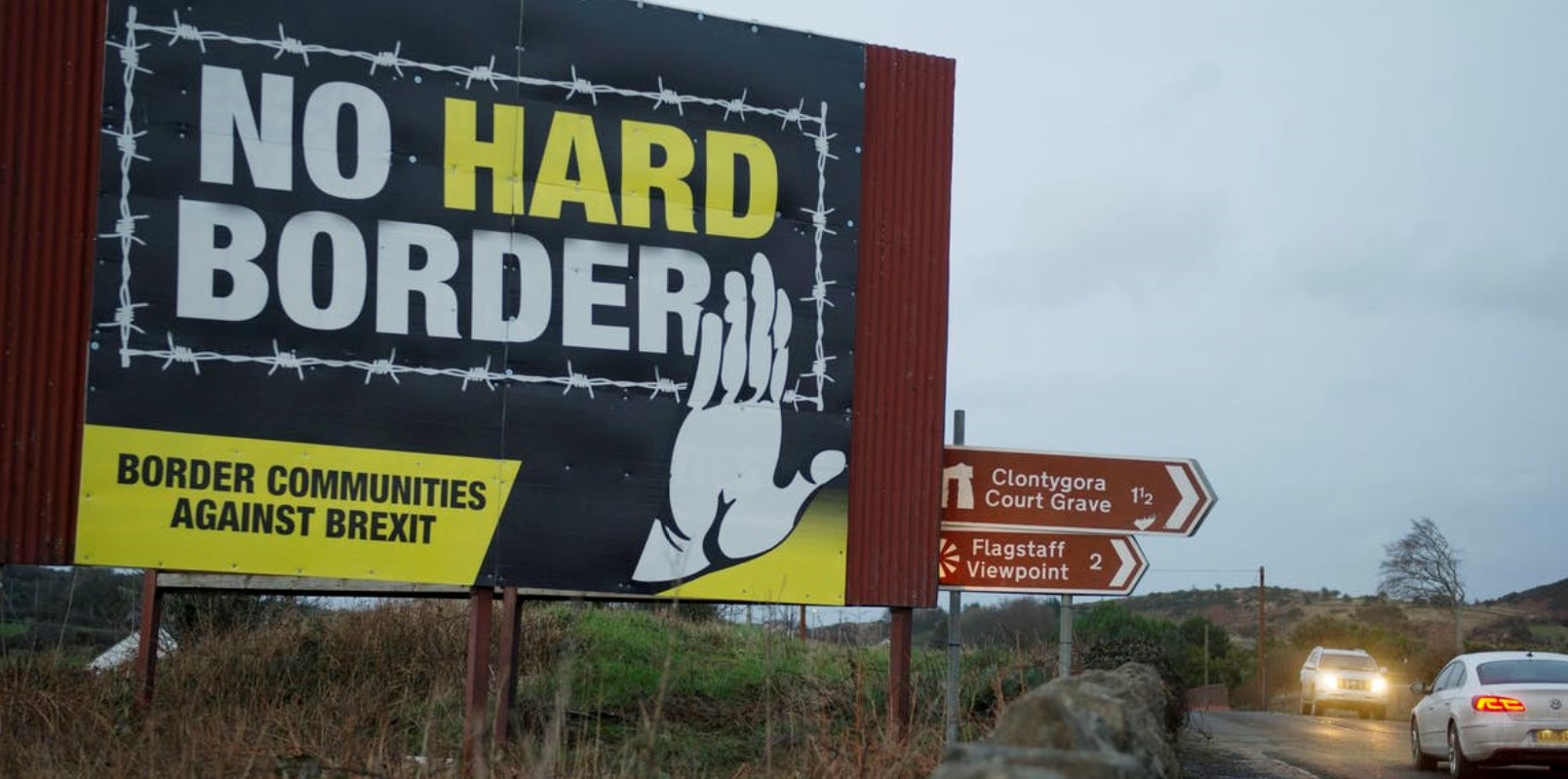 Anti-Brexit Northern Ireland road sign with wording 'no hard border' inside barbed wire
