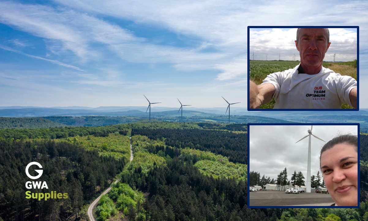 Three giant wind turbines on a hill in a forest, with blue sky behind and - inset - images of competition winners Clare Rhine and Colin McNicholl  