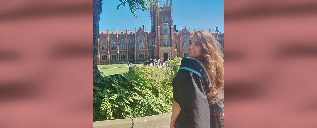 Mansion House scholar, Megan Edwards in graduation gown in front of Queen's building