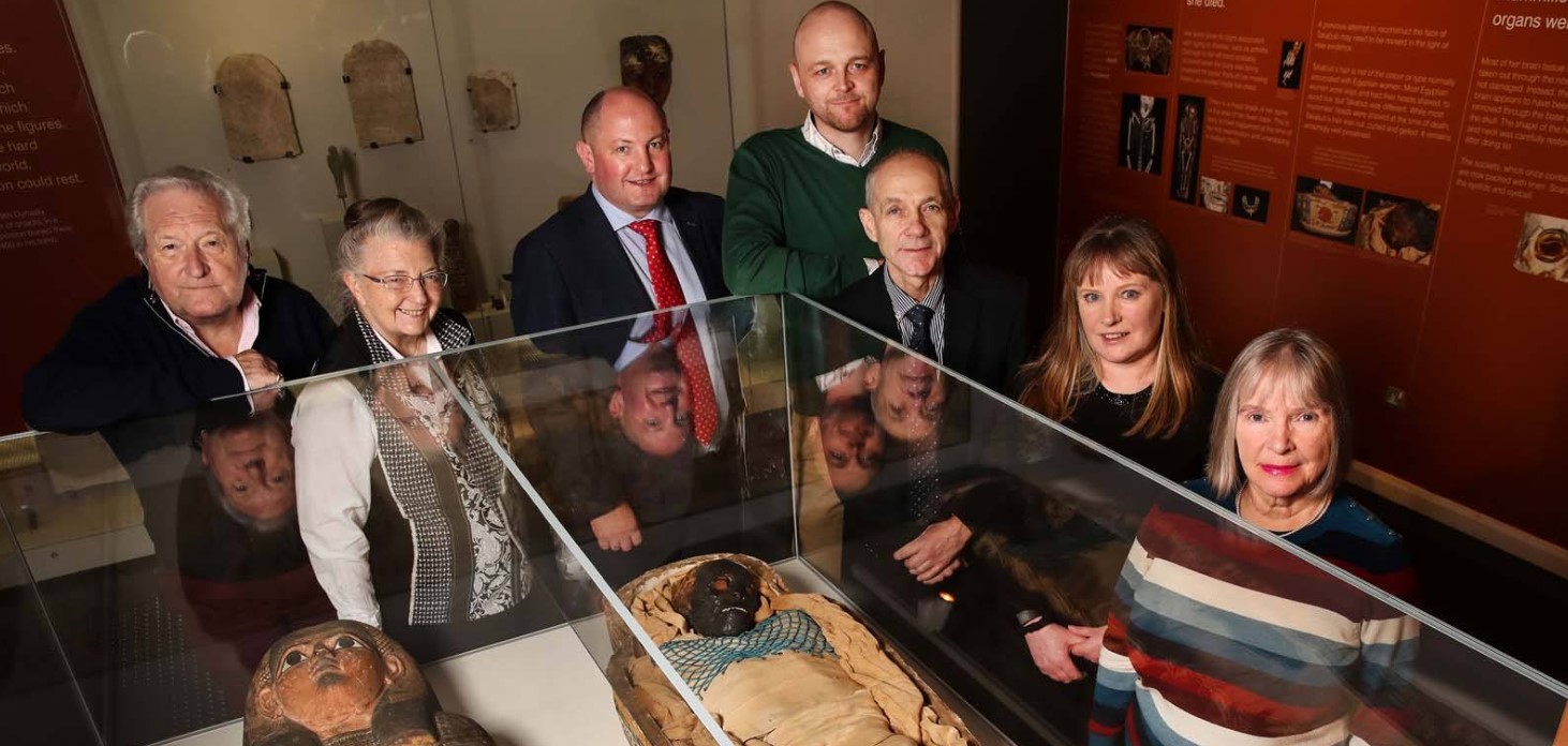 Group of visitors beside exhibit of Takabuti, Egyptian mummy in Ulster Museum 