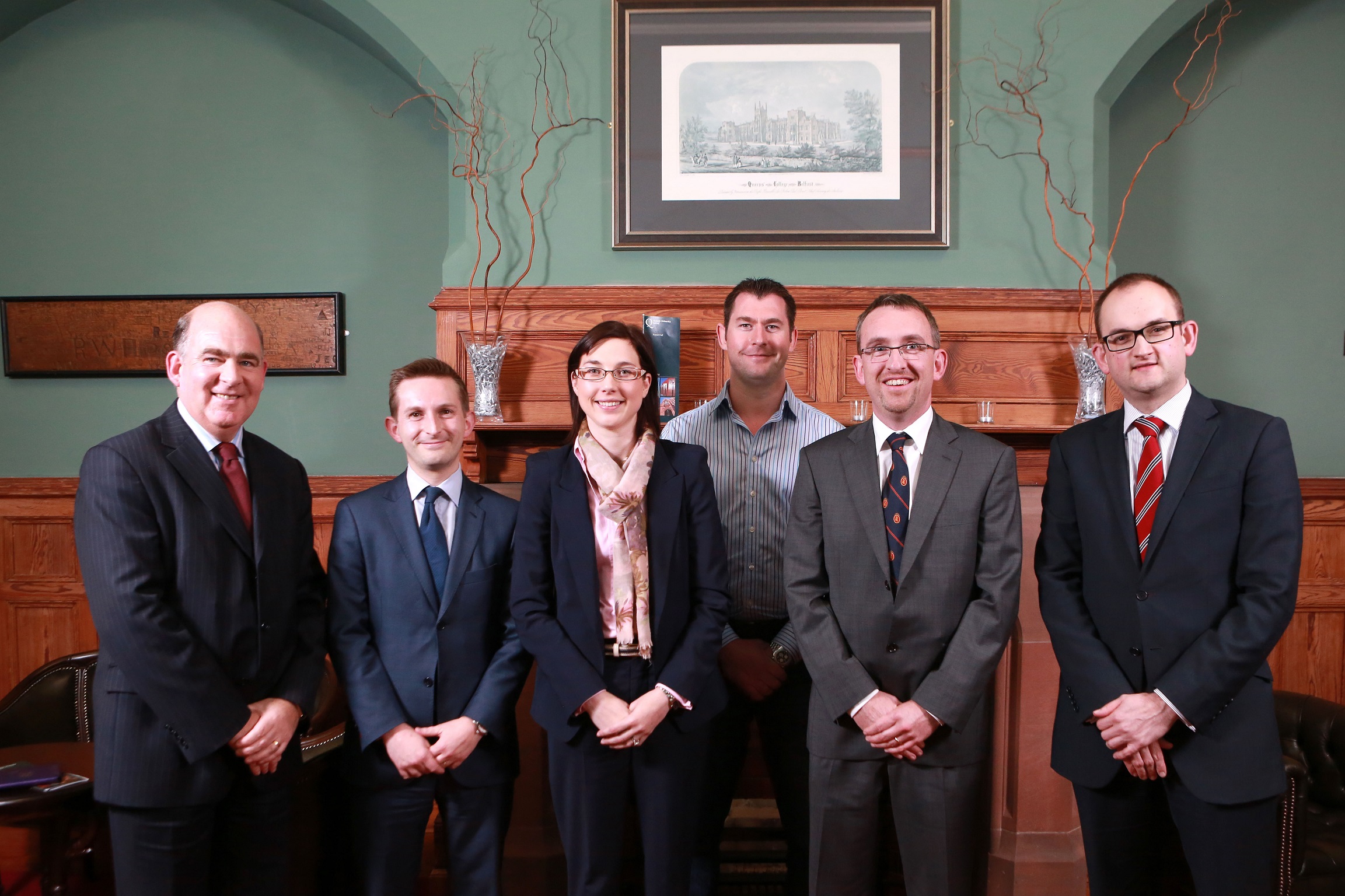 Panelists pictures with Professor John Turner, QUMS